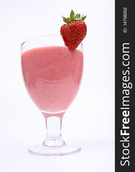 Strawberry shake in a glass decorated with a strawberry on white background