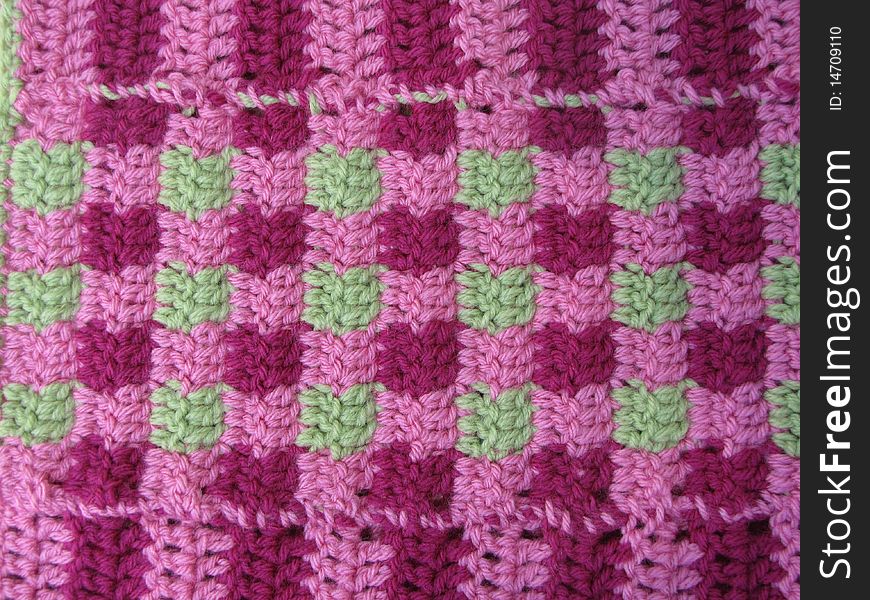 Pink and purple yarn blanket used as a blanket. Pink and purple yarn blanket used as a blanket