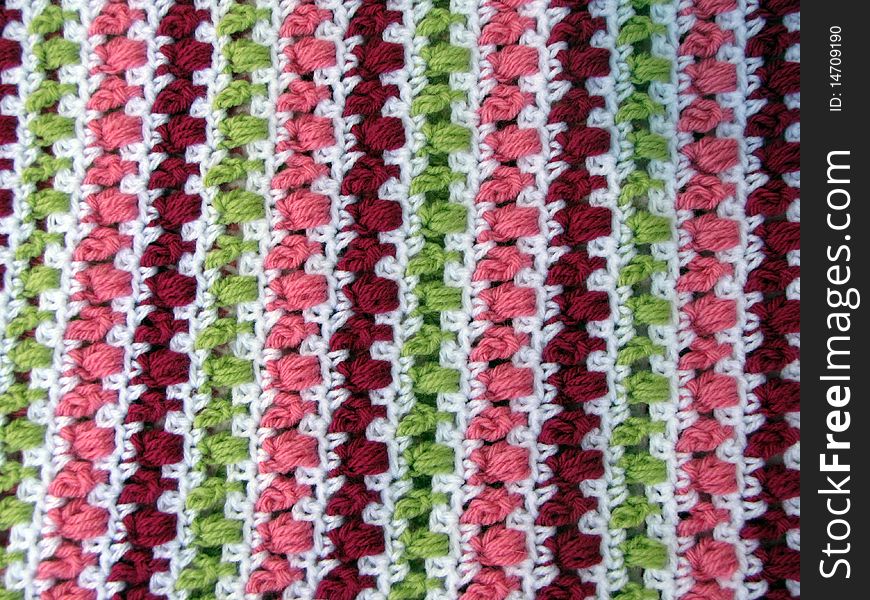 Colorful crocheted yarn blanket used as a background