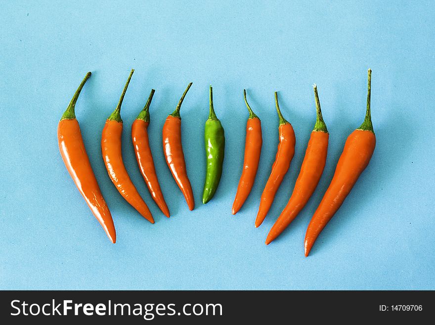 Red and green hot chili peppers on the table