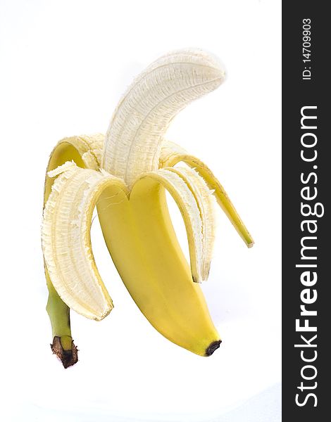 Half peeled banana on a white background. Half peeled banana on a white background