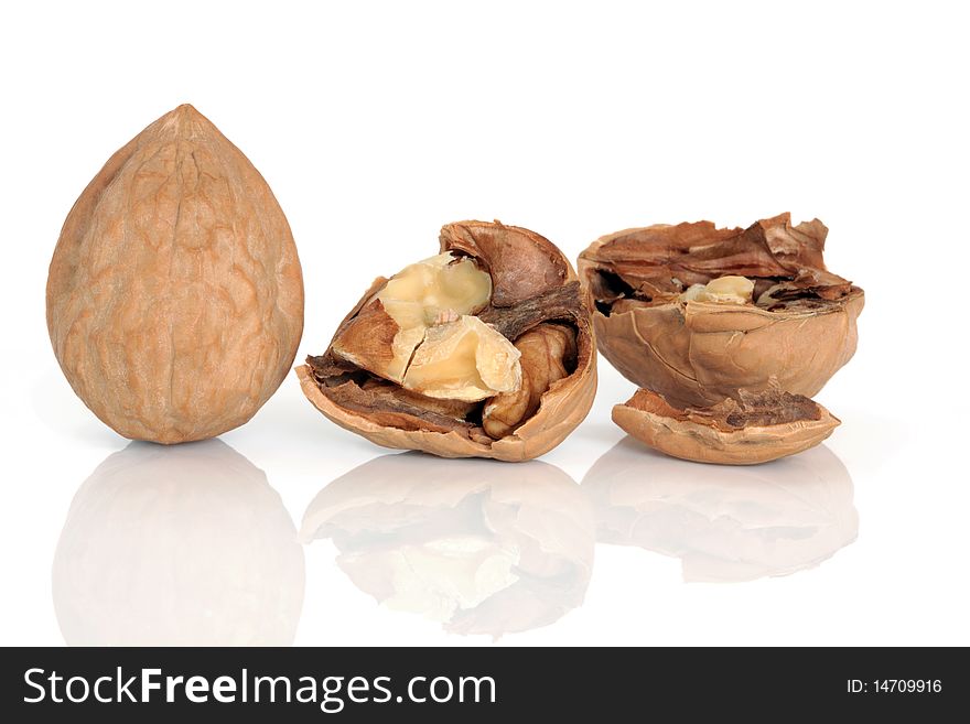 Walnut kernels whole and cracked open with shells, isolated over white background. Walnut kernels whole and cracked open with shells, isolated over white background.