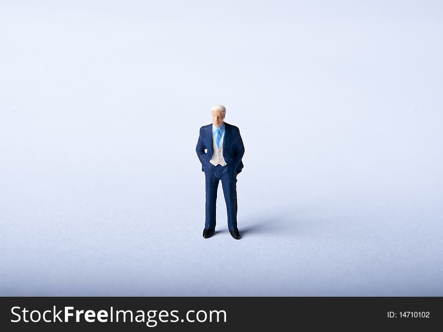 One miniature man standing alone