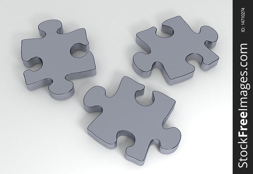 Three isolated 3D metallic puzzle pieces