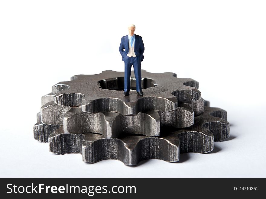 Miniature man on gears standing