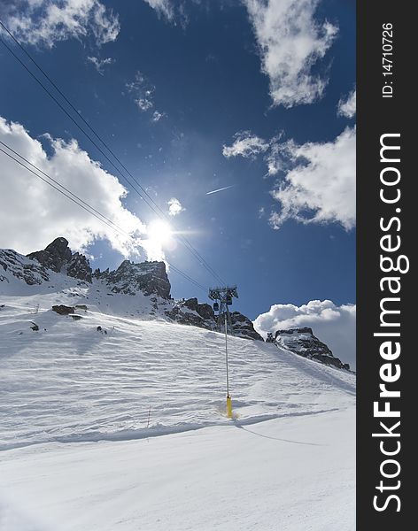 Cable car running alongside the skiing slope in the ski resort of Val Gardena. Dolomites, Italy. Cable car running alongside the skiing slope in the ski resort of Val Gardena. Dolomites, Italy.