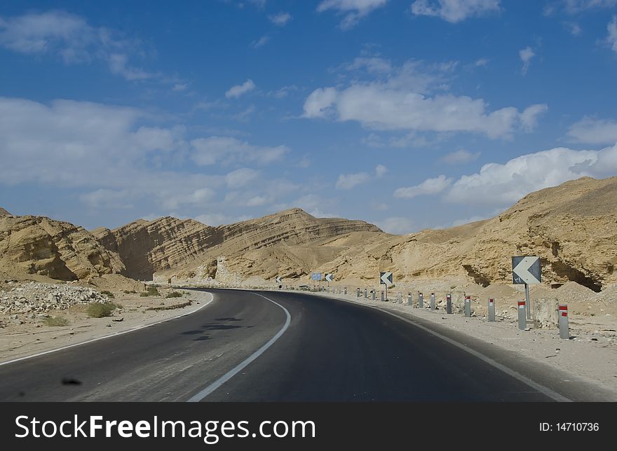 Desert road leading towards mountains in the distance. South Sinai, Egypt. Desert road leading towards mountains in the distance. South Sinai, Egypt.