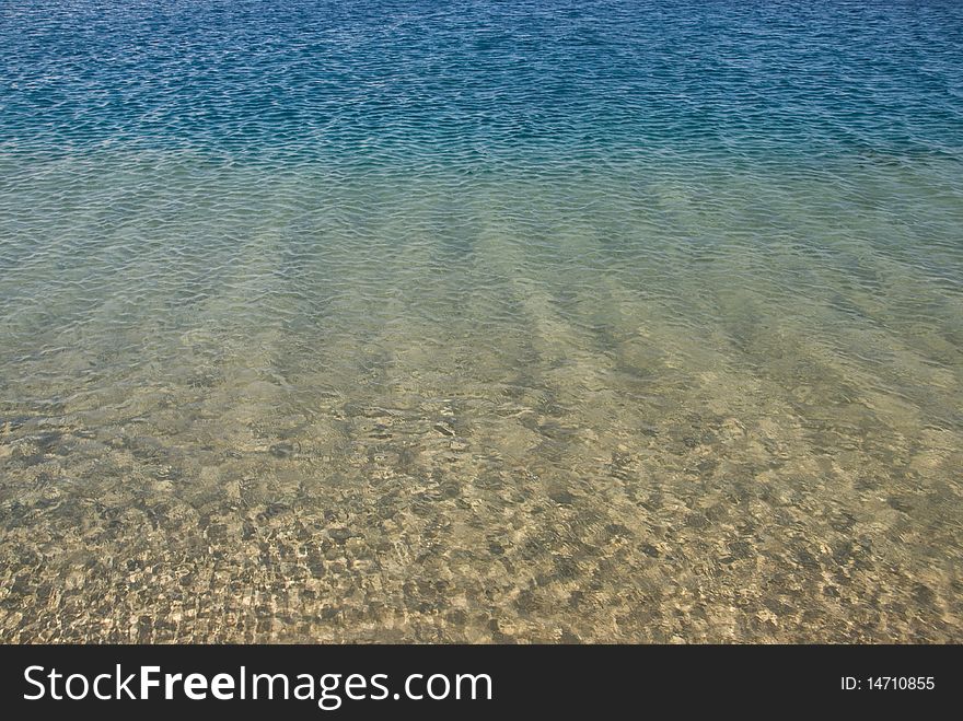 Gradated colors of the sea in shallow water with the ripples reflected on the sand below. Ras Mohamed National Park, South Sinai, Red Sea, Egypt. Gradated colors of the sea in shallow water with the ripples reflected on the sand below. Ras Mohamed National Park, South Sinai, Red Sea, Egypt.