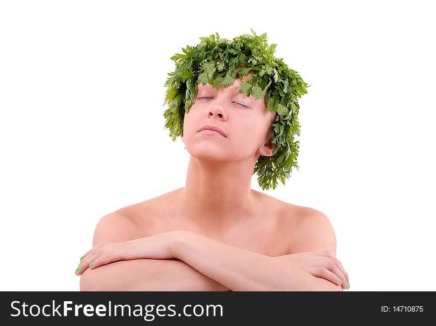 Young woman with green leafy hair made from parsley is relaxing. Studio shot on a white background. Young woman with green leafy hair made from parsley is relaxing. Studio shot on a white background.