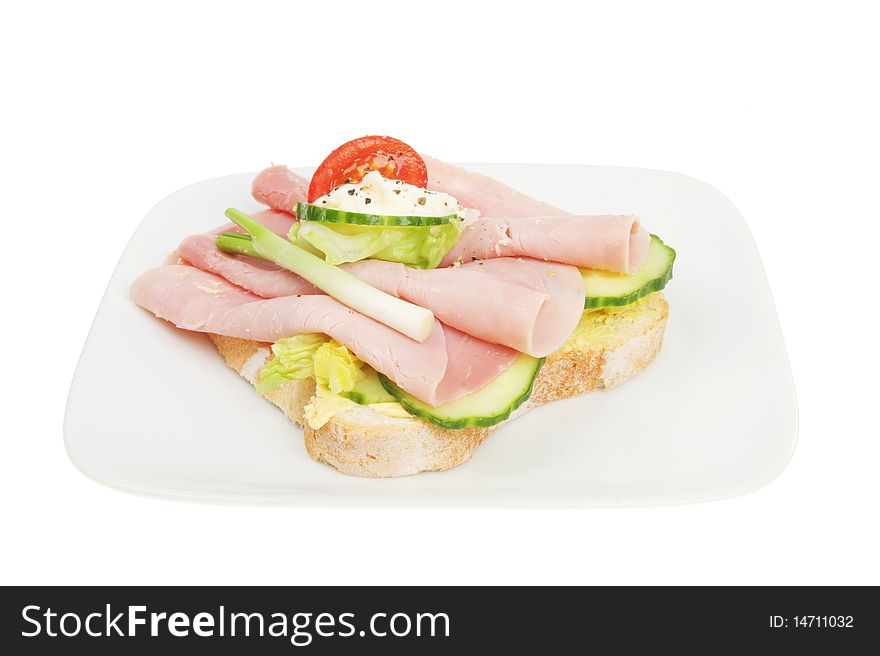 Open ham sandwich on plate