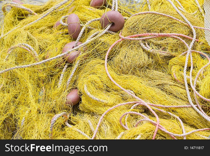 Tangled nylon yellow fishing tackle close-up: net, float, cord. Tangled nylon yellow fishing tackle close-up: net, float, cord