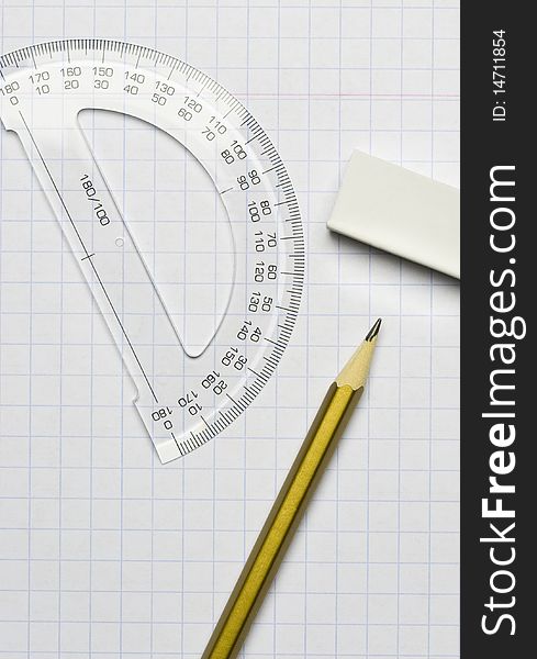 A pencil, an eraser and a ruler on the exercise book