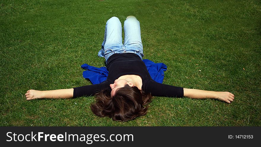 A woman having a relaxing sleep in a field