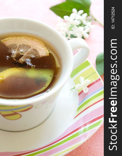 Tea with slice lemon in a floral cup. Tea with slice lemon in a floral cup