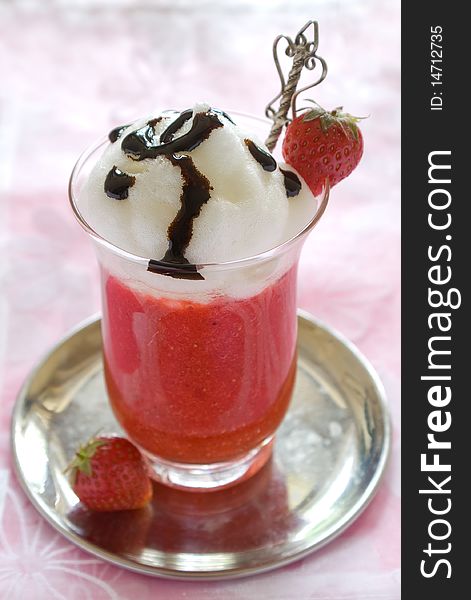 Strawberry dessert decorated with fresh strawberry and syrup