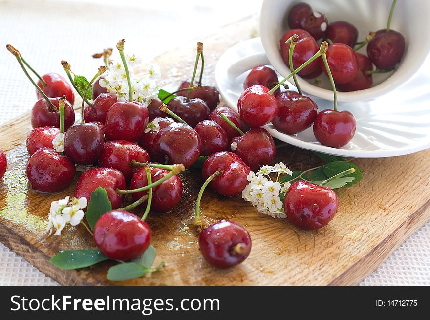 Beautiful  fresh cherry in a board with white cup