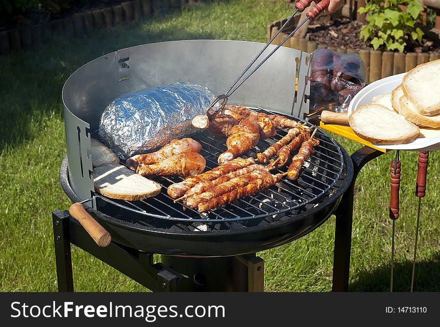 Grilling meat at summer weekend