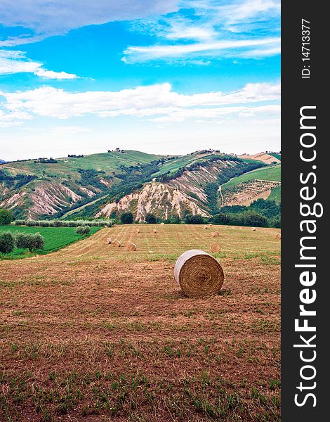 Typical rural landscape of the Italian countryside with bales of hay.