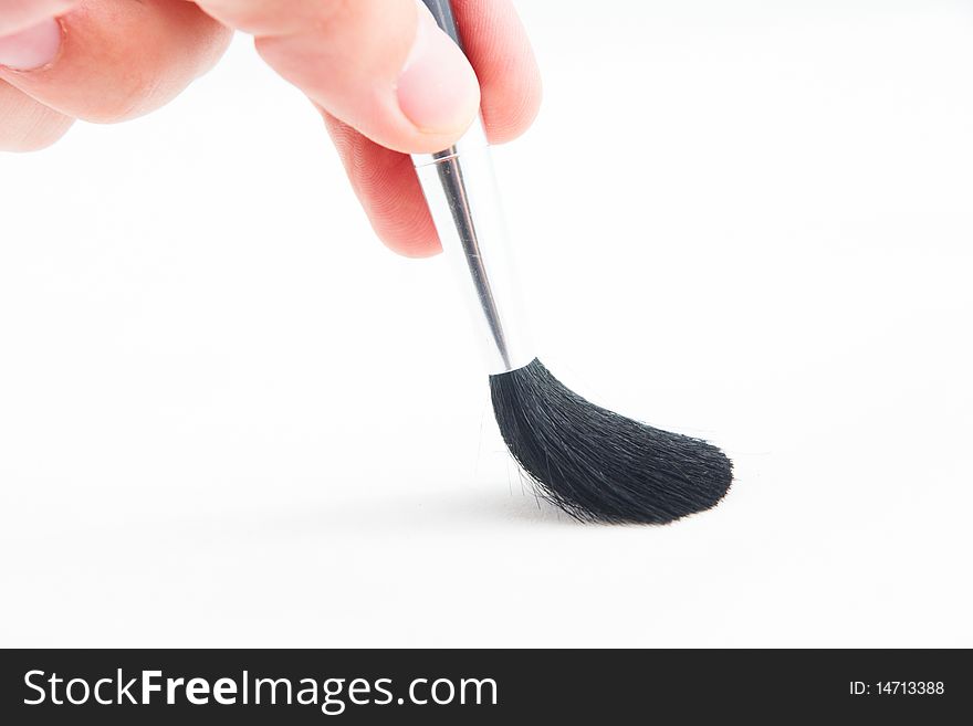 A hand with tassel on white