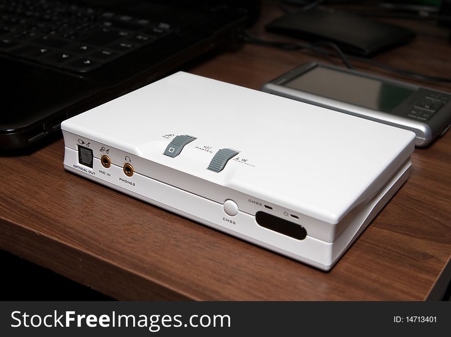 External white sound card on a desk. External white sound card on a desk.