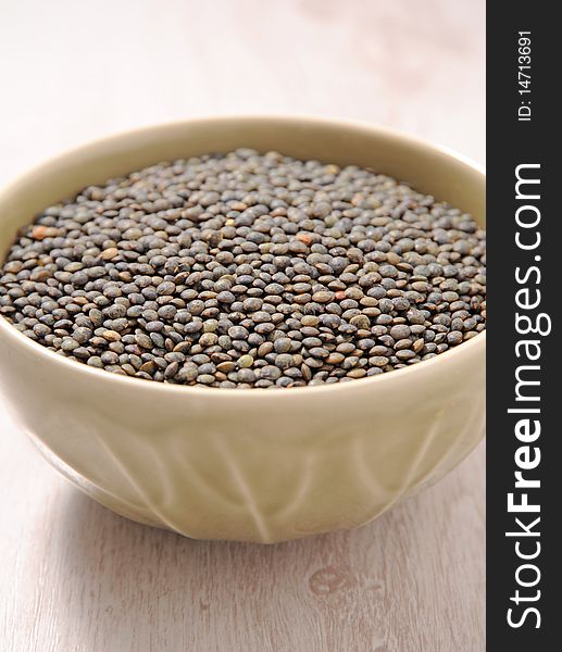 Bowl of brown dried lentils. Bowl of brown dried lentils