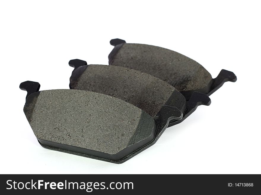 Three clean isolated disc brake pads. Three clean isolated disc brake pads