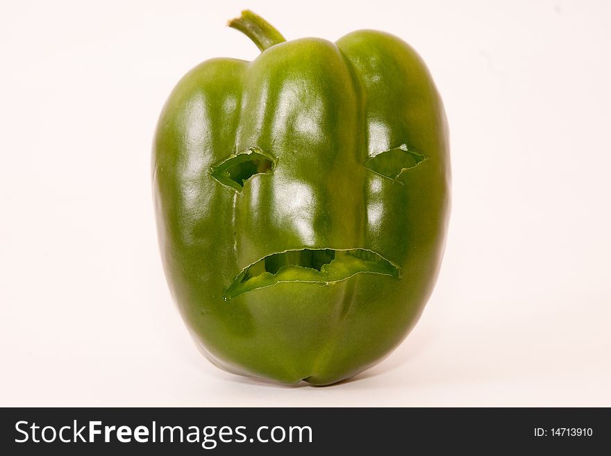 Sad green bell pepper with face above white. Sad green bell pepper with face above white