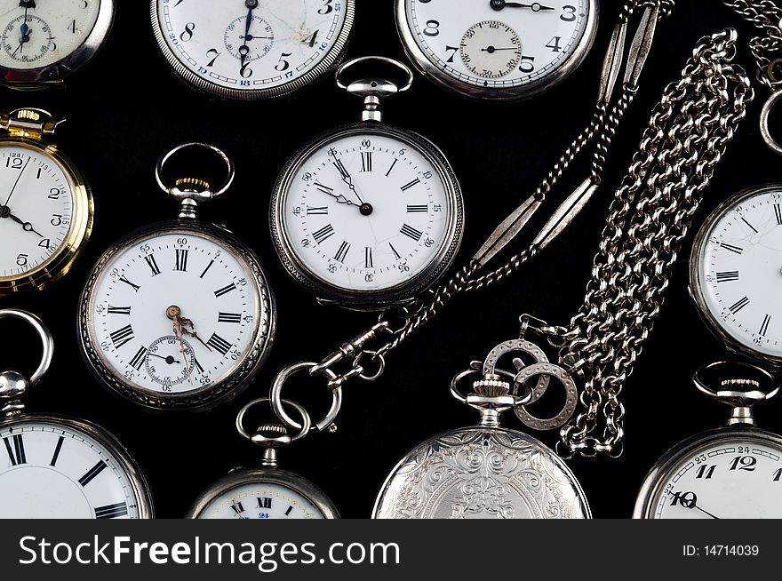 Background of cracked silver pocket watch on black