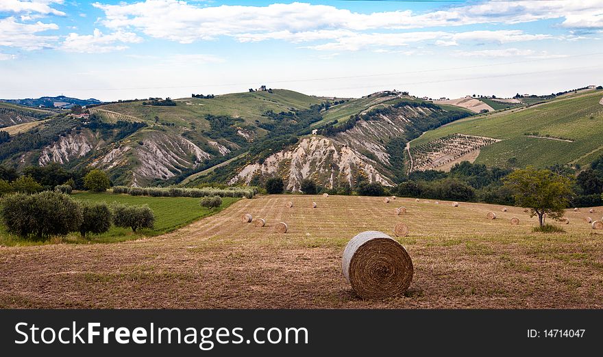 Typical rural landscape of the Italian countryside with bales of hay.