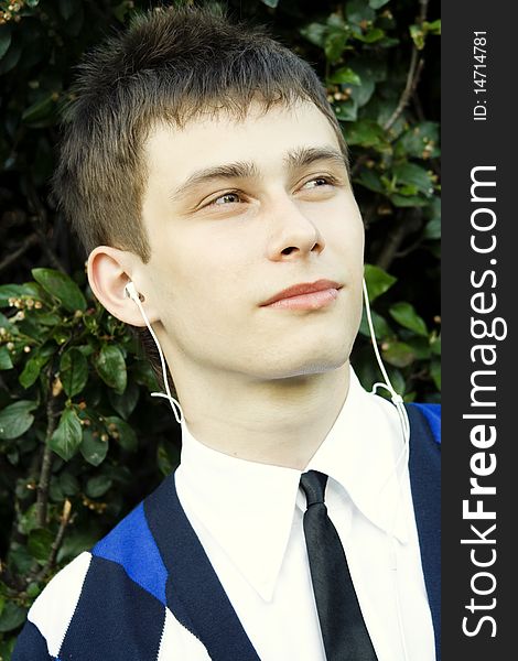 Teenager in a park listening to music