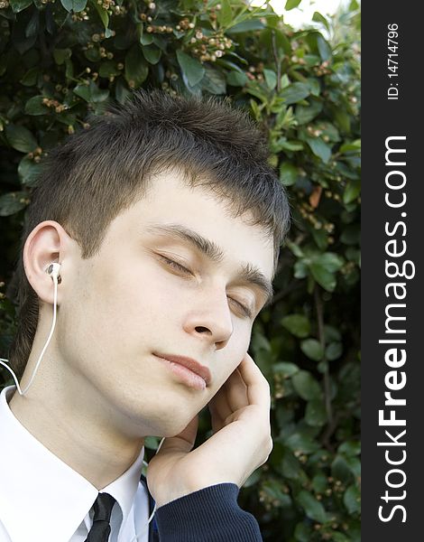 Teenager in a park listening to music