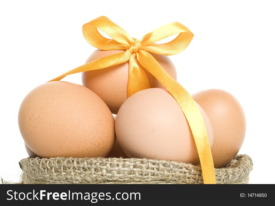 Chicken eggs in the basket. Isolated on white background