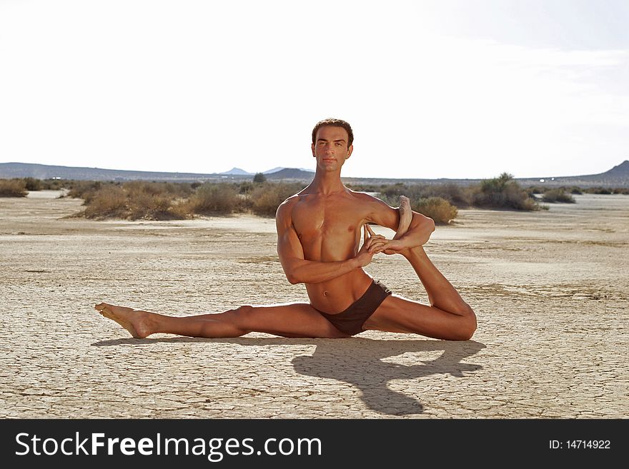 Young man performing Yoga pose in the desert. Young man performing Yoga pose in the desert