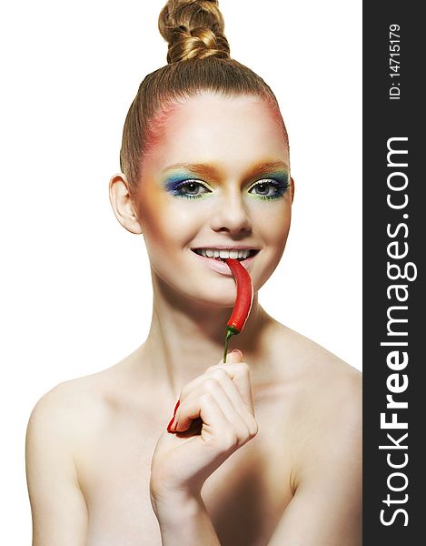 Young woman with bright cosmetics on a white background and with red pepper. Young woman with bright cosmetics on a white background and with red pepper