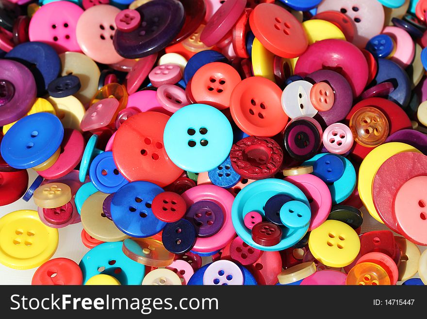 An assortment of colored buttons in shape, size and color. An assortment of colored buttons in shape, size and color.