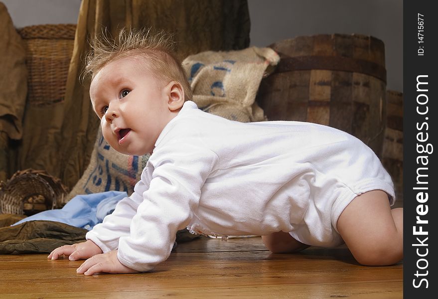 Close up of smiling baby crawling on a floor. Close up of smiling baby crawling on a floor