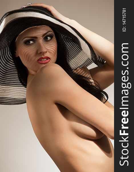 Model in striped hat topless