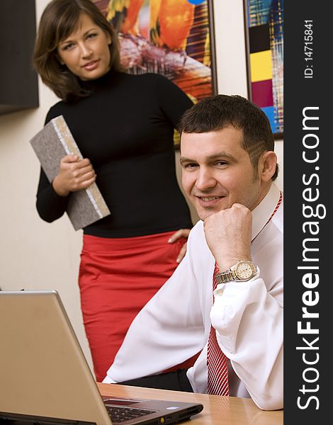 Two colleagues working in office