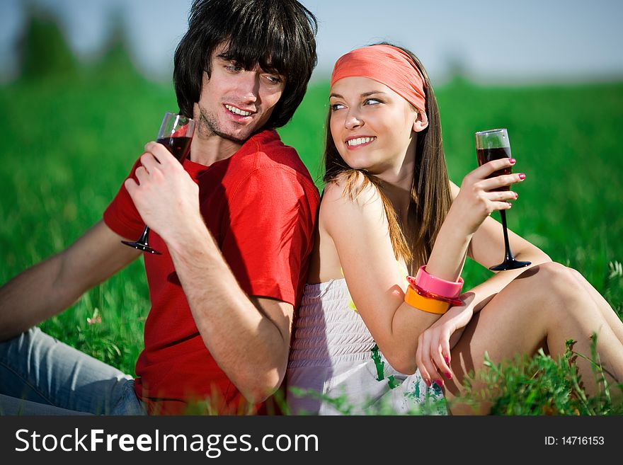 Beautiful girl in kerchief and boy with wineglasses