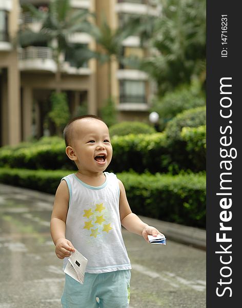 It is a cute happy chinese baby on the outdoor. It is a cute happy chinese baby on the outdoor.