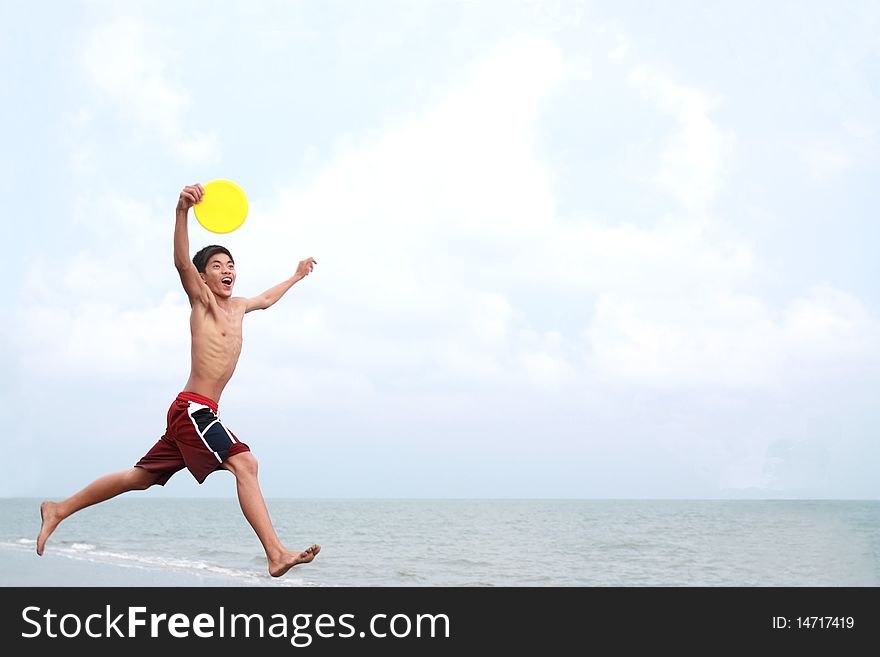 Happy young man jumping at the beach. Happy young man jumping at the beach