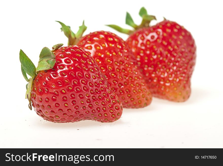 Juicy strawberries isolated on white background