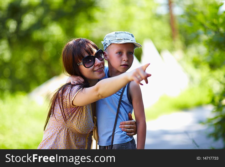 Young Mother Hugging Her Child Outdoor