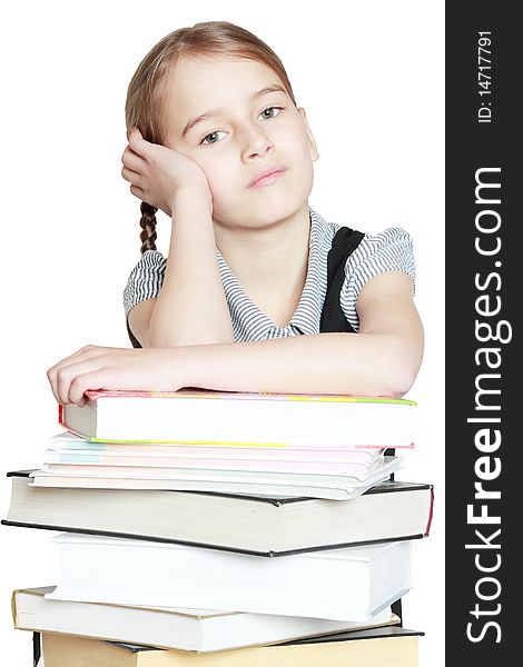 Young girl leaned over pile of books isolated on white. Young girl leaned over pile of books isolated on white