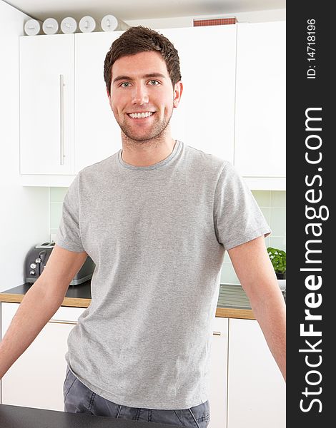 Young Man Relaxing In Modern Kitchen