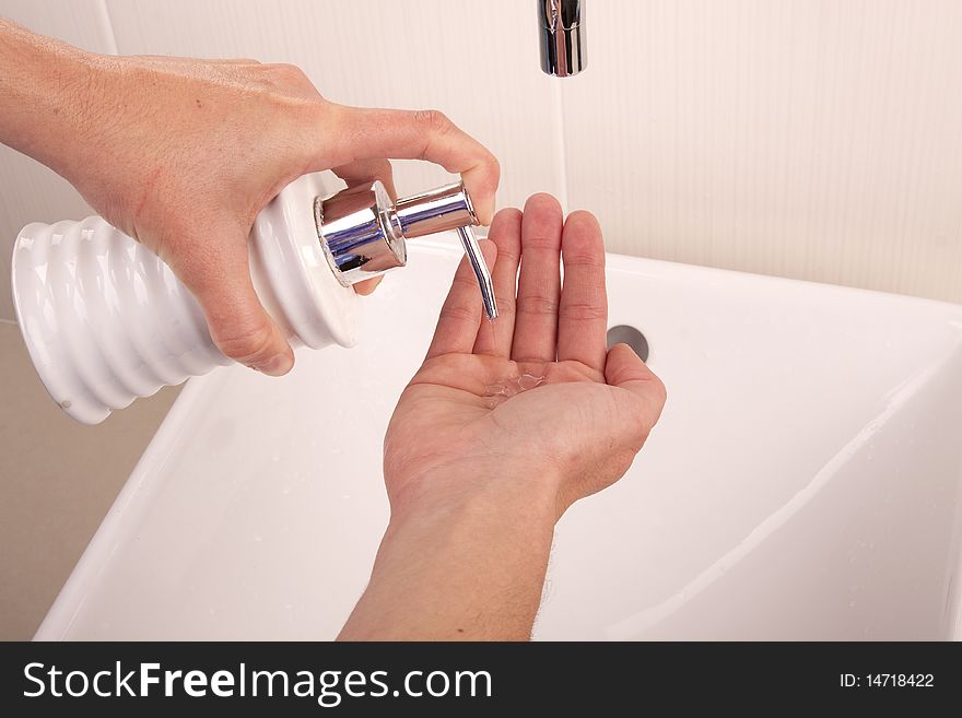 Squirting liquid soap into the palm of a hand. Squirting liquid soap into the palm of a hand