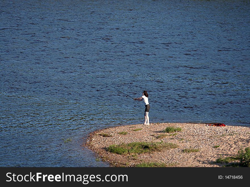 Girl catches a fish the bait on a small island. Girl catches a fish the bait on a small island