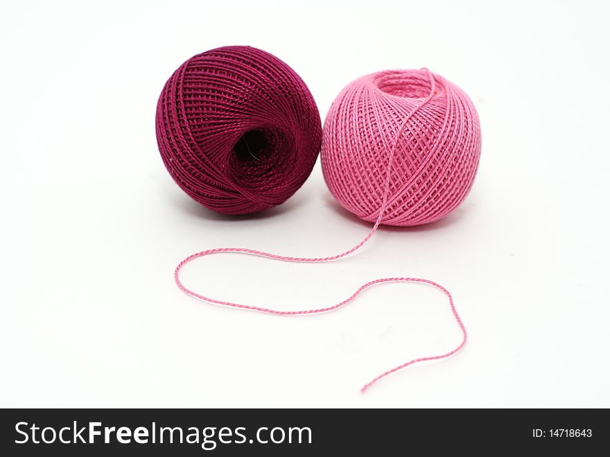 Cotton yarn balls of pink and purple color isolated on white background. Cotton yarn balls of pink and purple color isolated on white background