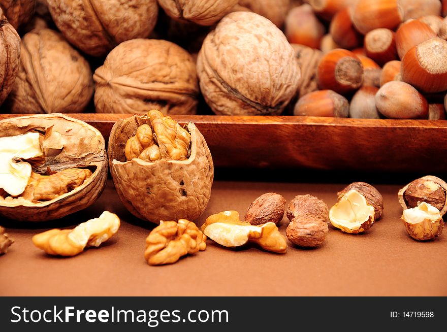 Walnuts and hazelnuts in a wooden bowl. Walnuts and hazelnuts in a wooden bowl
