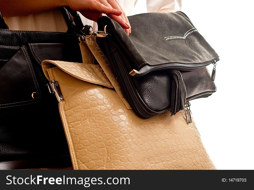 Three bags in woman's hand. Isolated on white